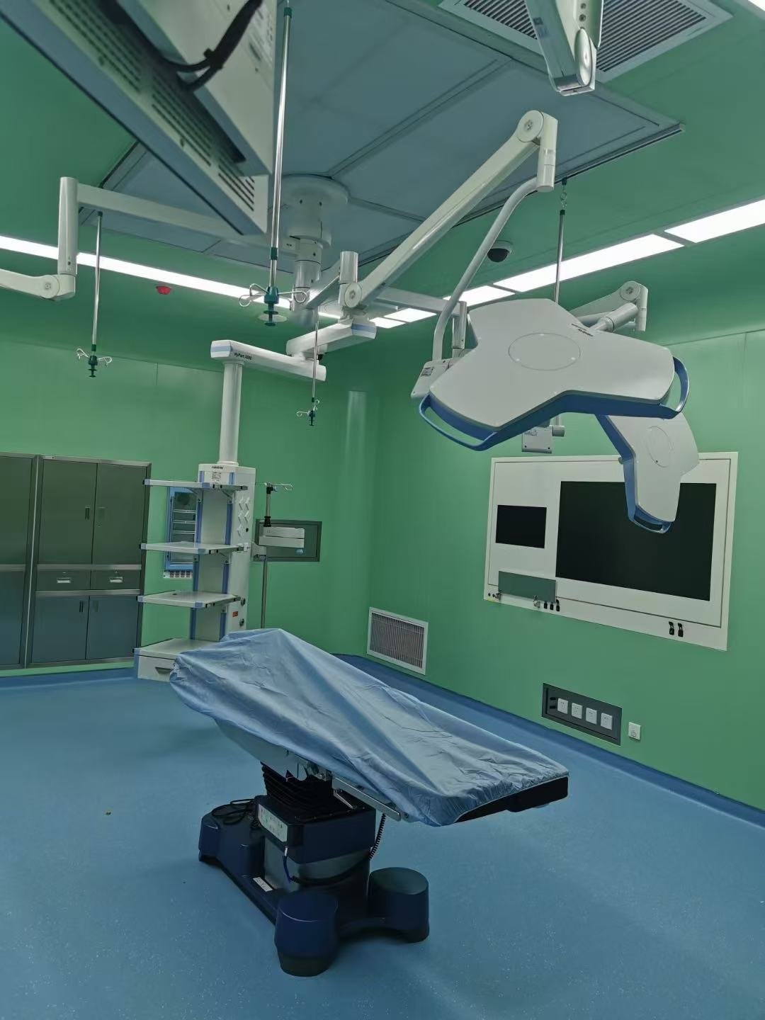 Green operating room with surgical table
