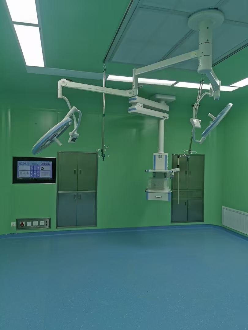 Green operating room with ceiling pendants