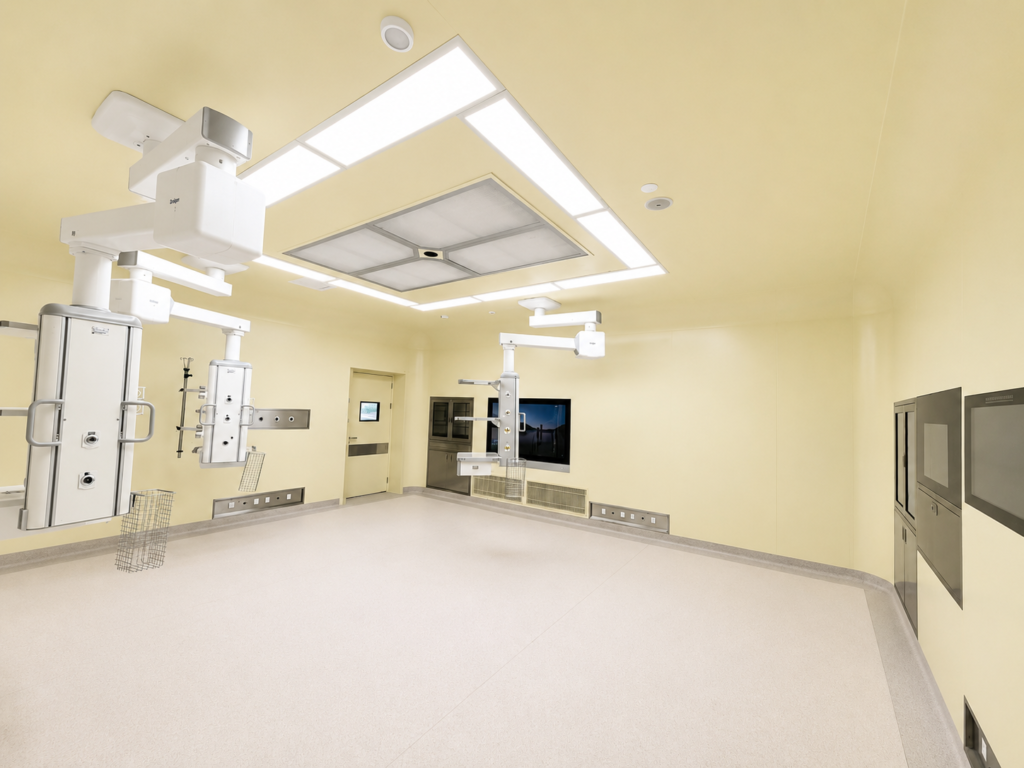 Operating theater wall panel chemical resistance illustrated by wiping a modular wall surface beside a sealed panel joint
